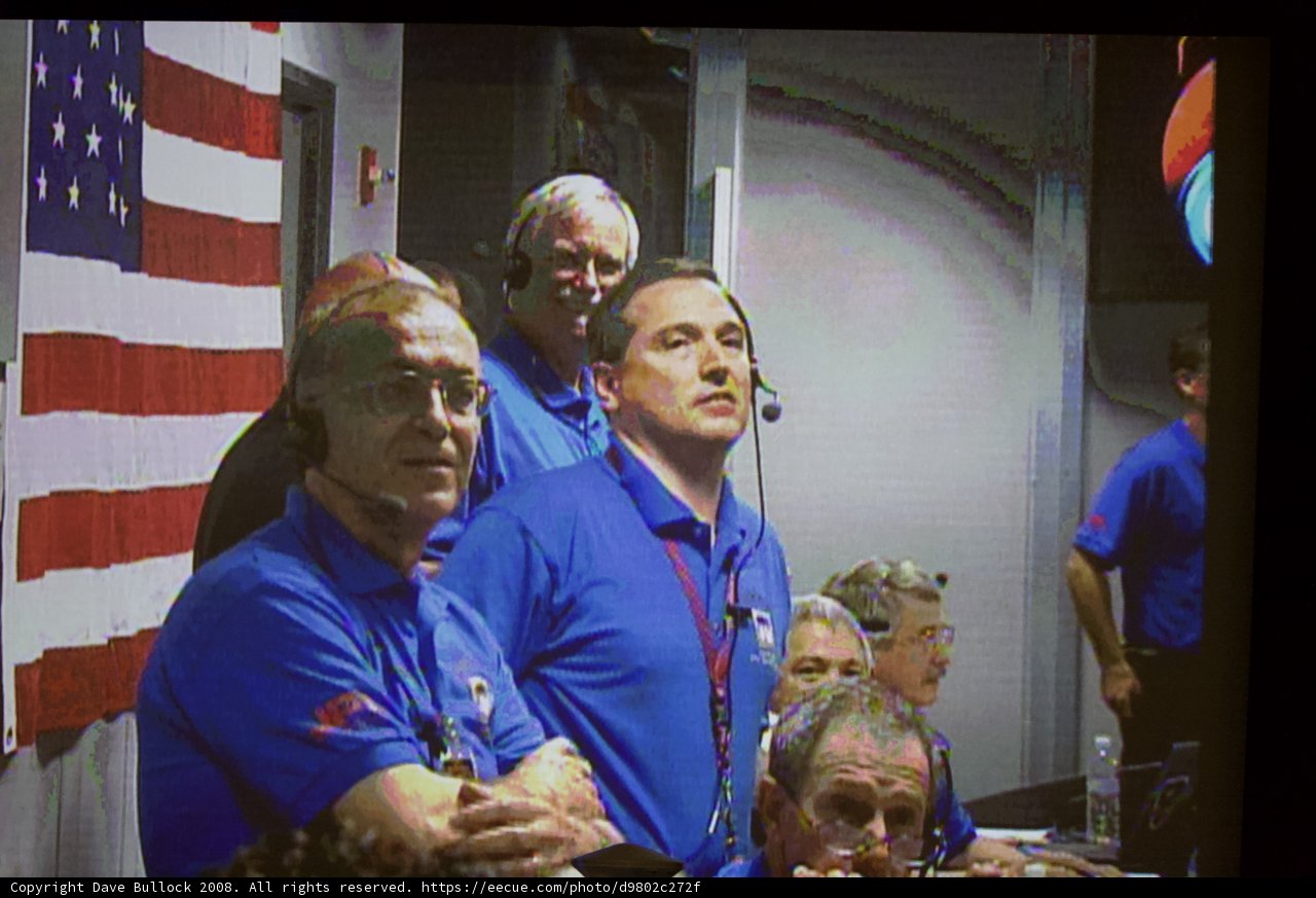 Men in Blue Shirts Watching TV