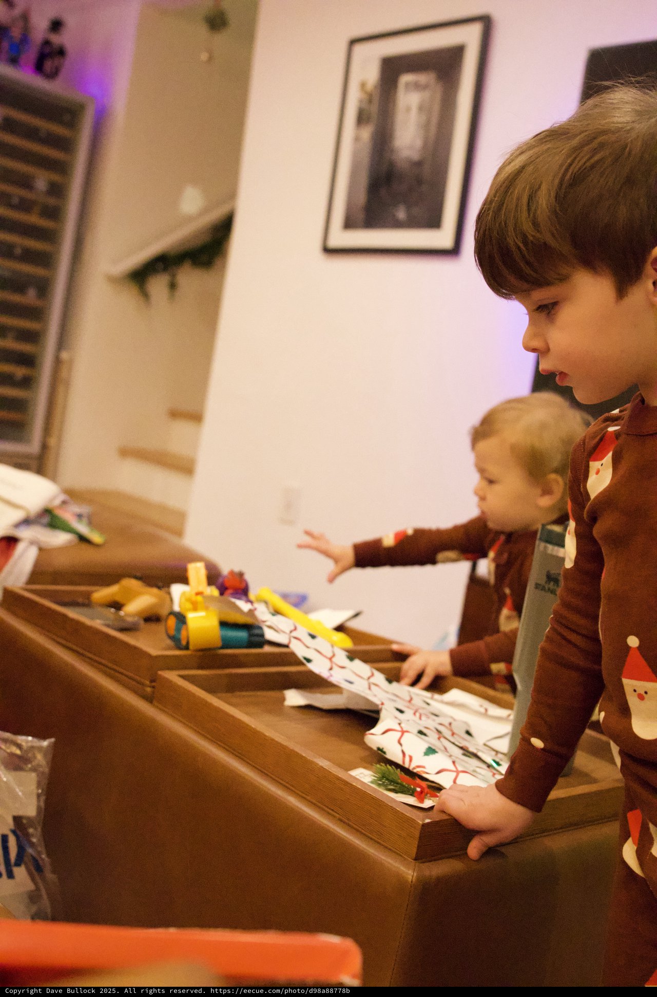Brothers Unwrapping Christmas Presents Together at Home