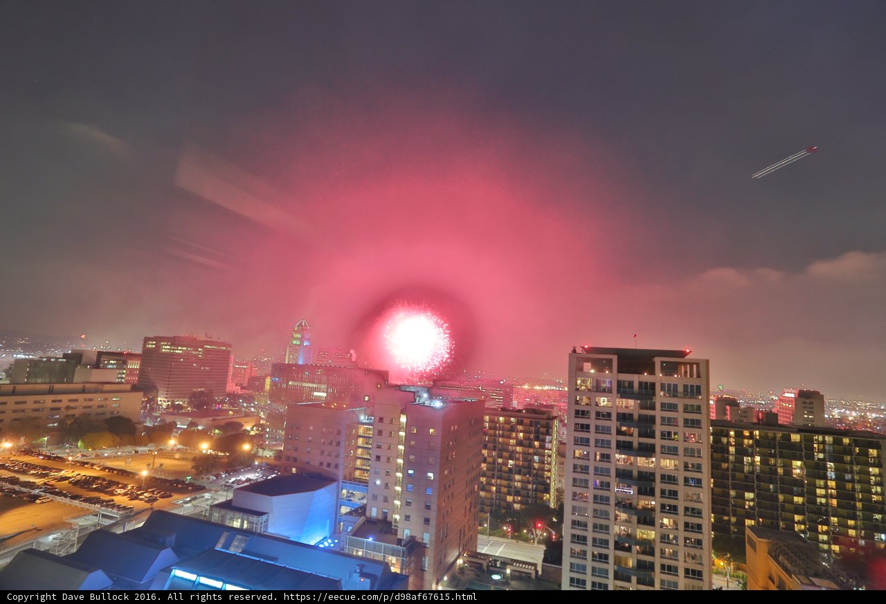 City Lights Bursting: A Fireworks Display over Urban Skyscrapers