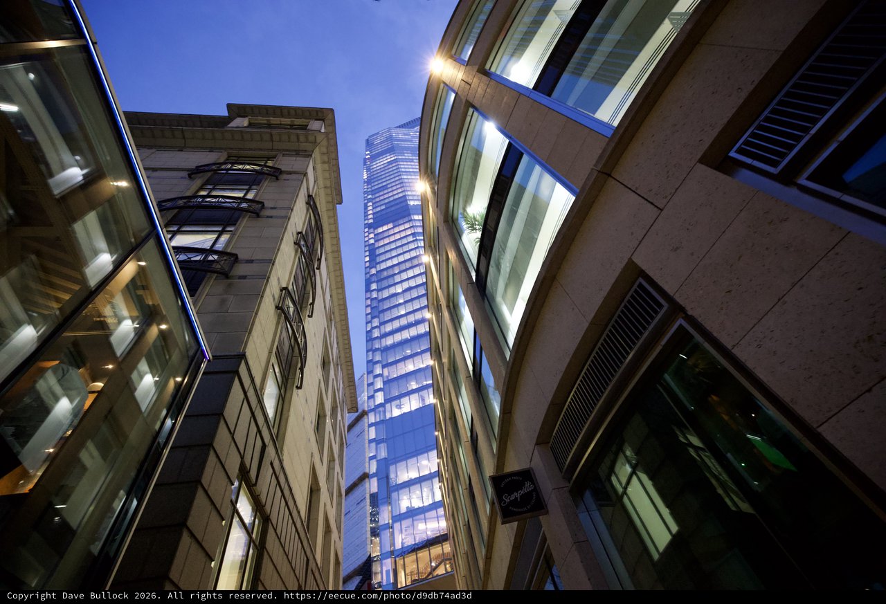 Modern Skyscraper Rising Between Historic London Buildings at Dusk