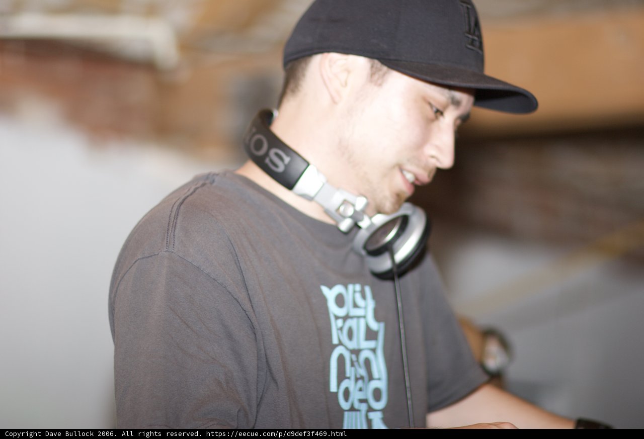 Black Shirted Man with Baseball Cap and Headphones