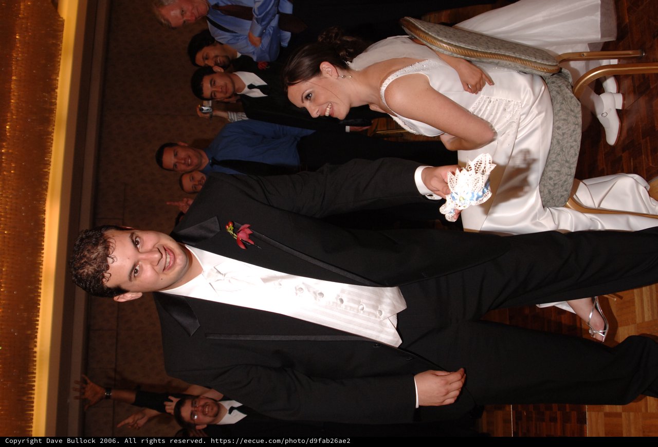 Groom Removes Garter at Joyful Wedding Reception