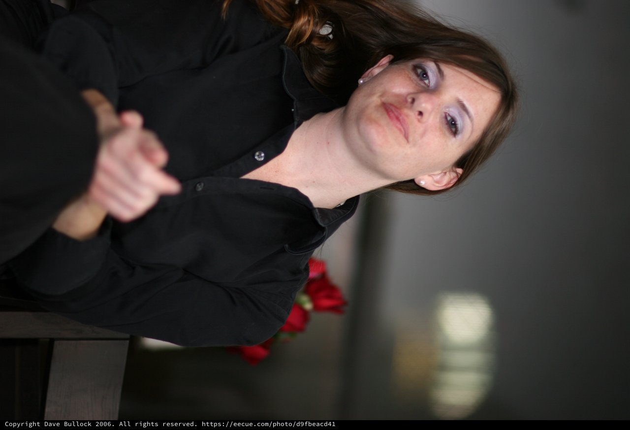 Contemplative Woman in Black at Office Setting