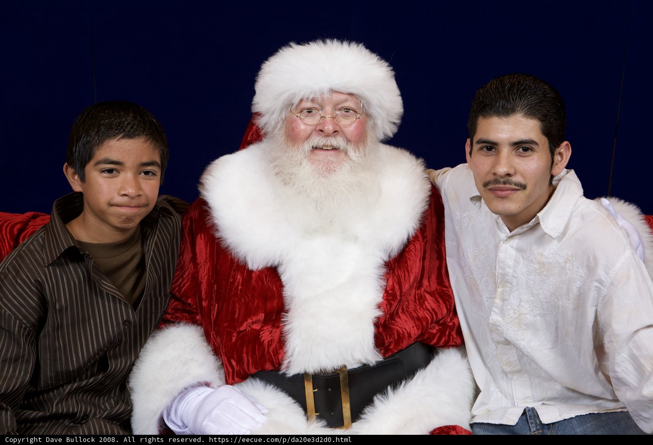 Santa Claus spreading joy with two boys at 2008 APC Xmas party