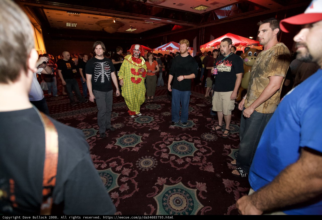Partygoers gather around clown for a night of fun