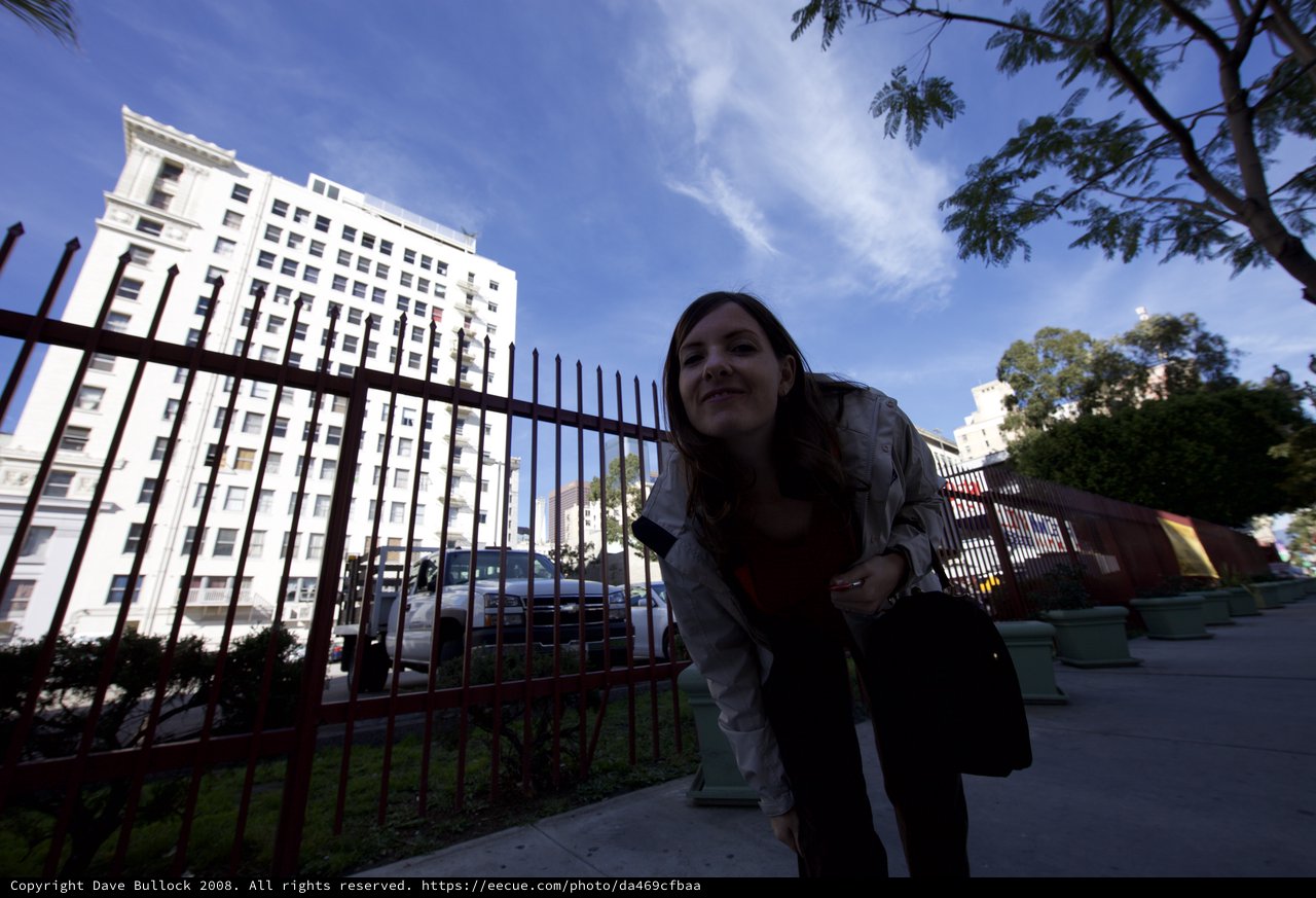 Urban Explorer Leaning at Downtown City Fence