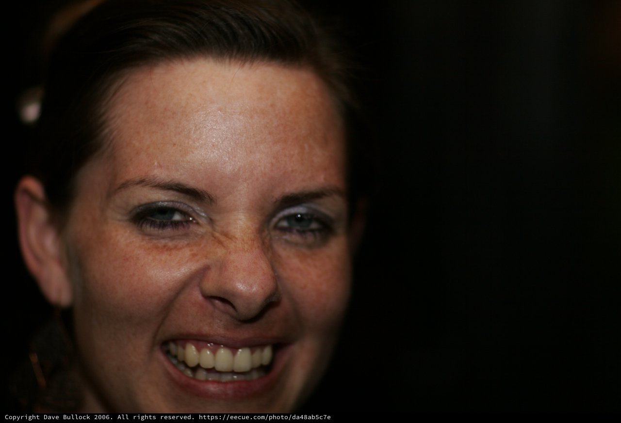 Joyful Woman Laughing in Dark Setting