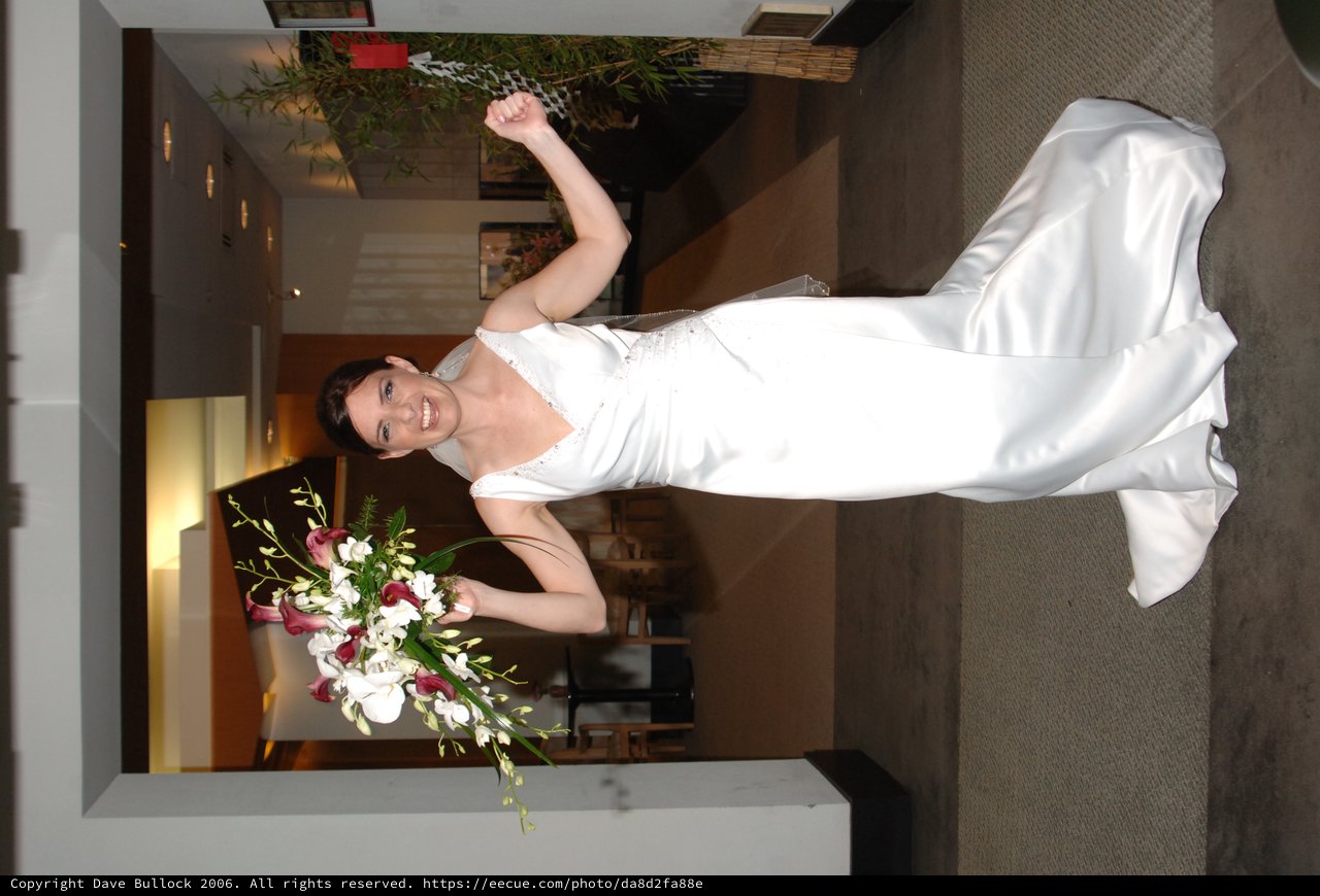 Jubilant Bride Celebrates with Bouquet Raised High