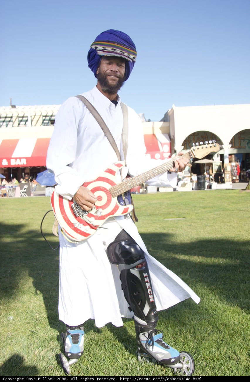 Turbaned Musician on Skateboard