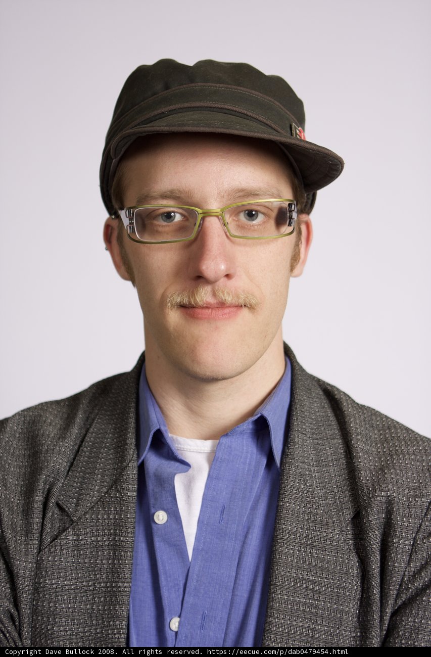 Elegantly Dressed Gent with Glasses and Fedora
