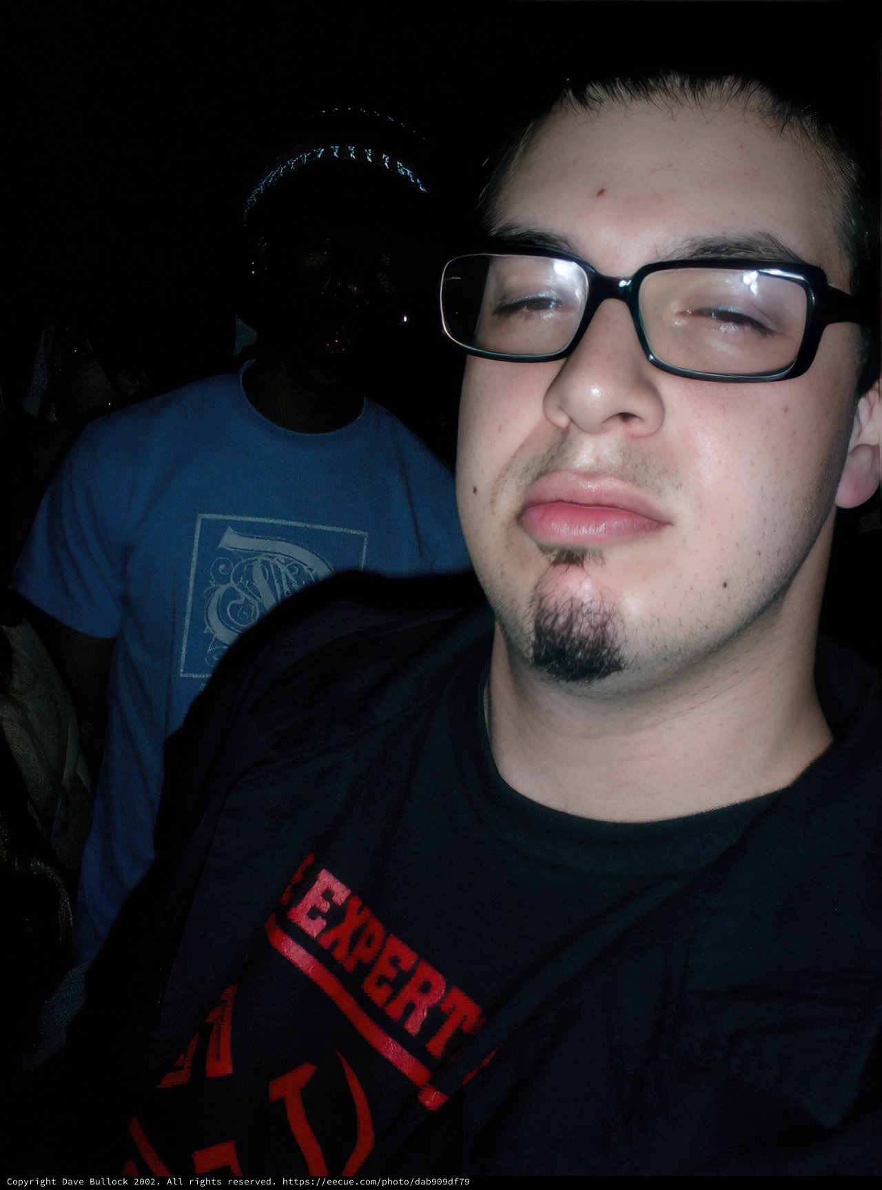 Dave B poses in black shirt and glasses