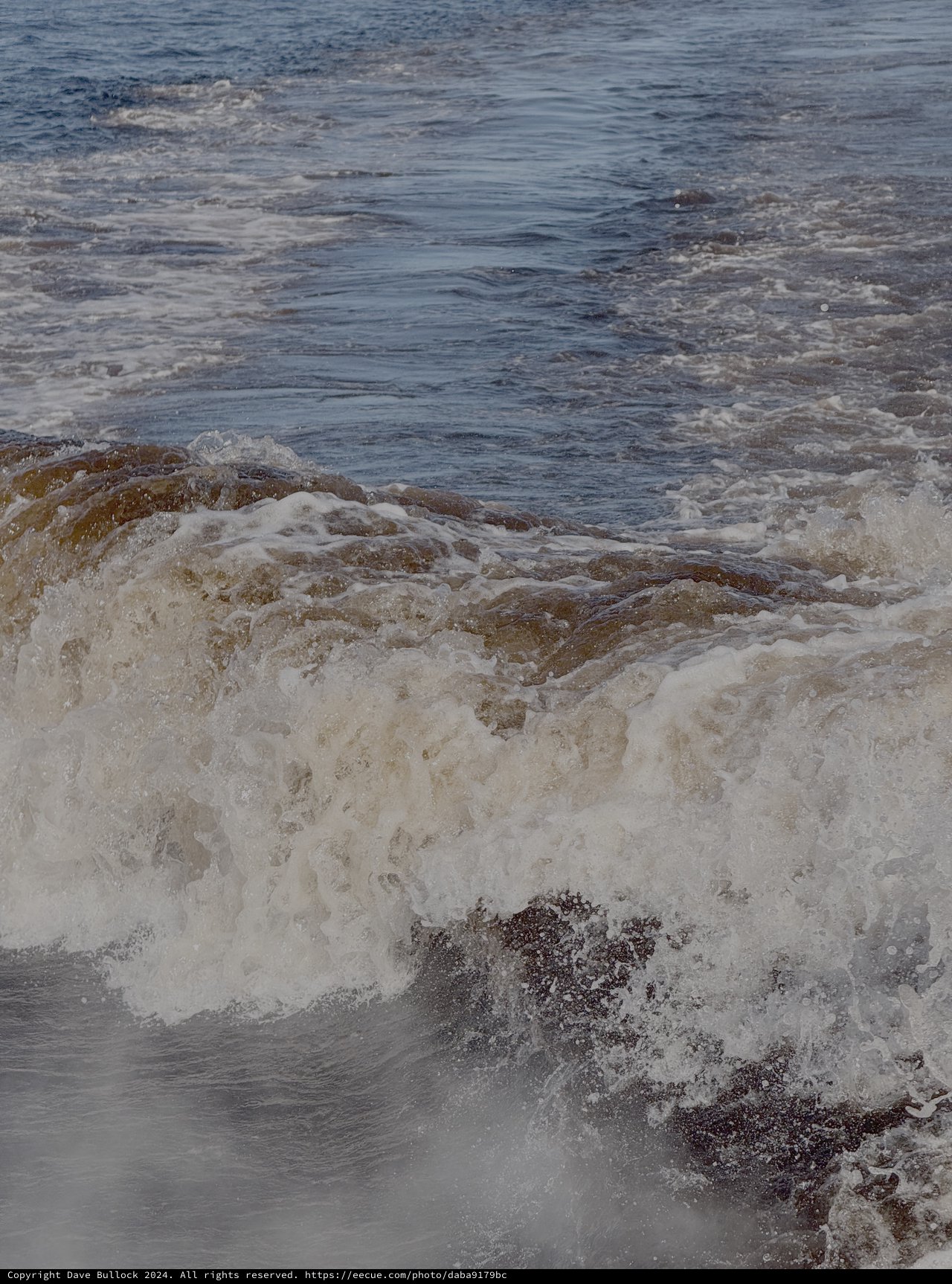 Ocean Waves Crashing Against Rocky Shore