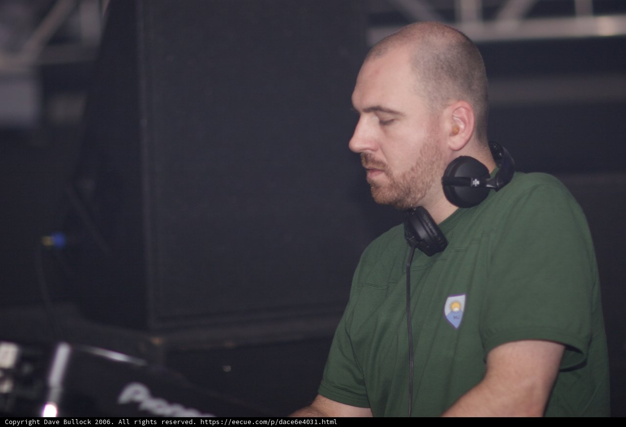 Green Shirt DJ Spinning the Decks