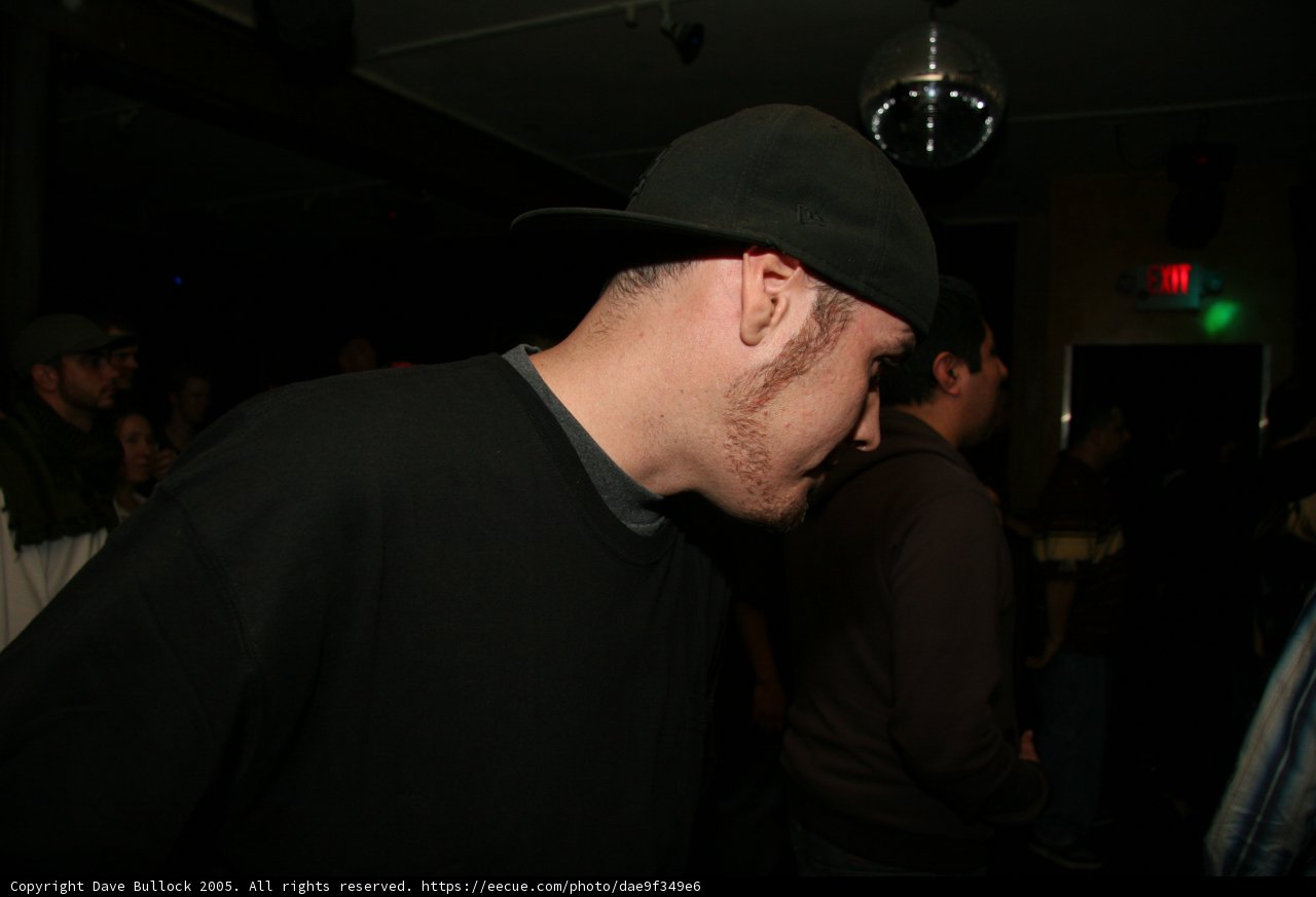 Hat-Wearing Man in a Crowd