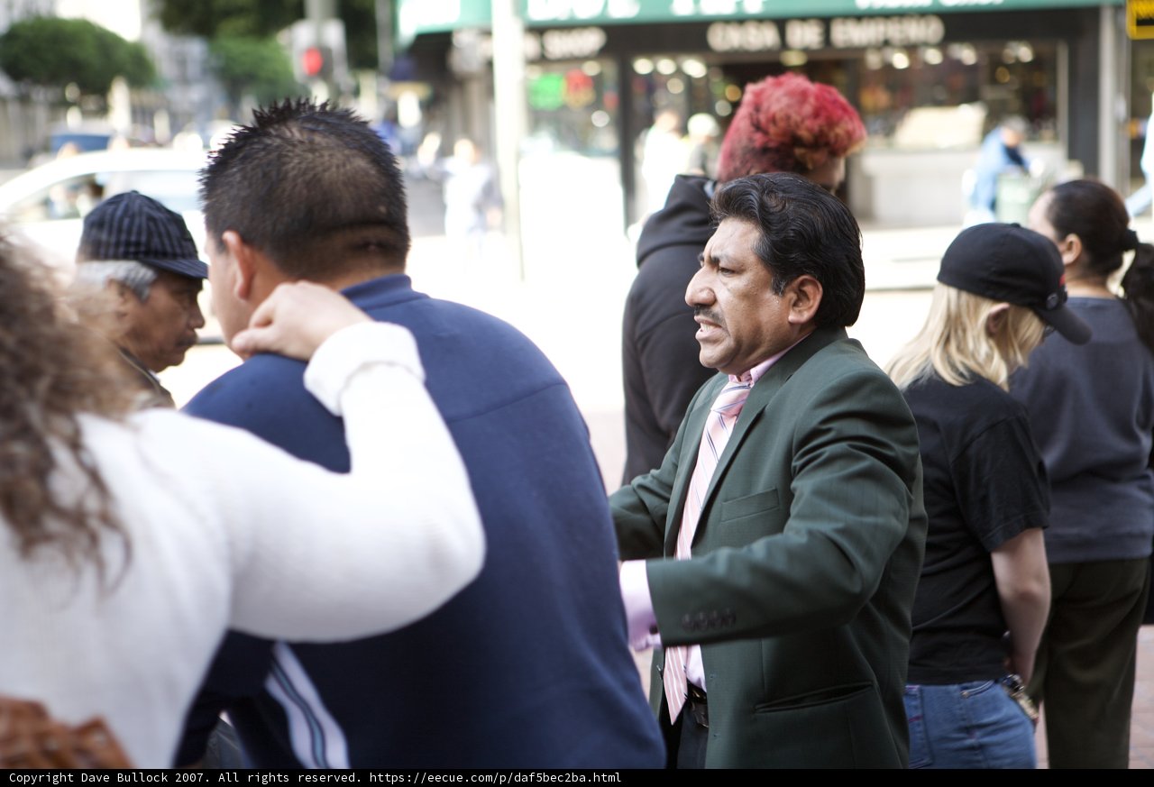 Man in a Suit and Cap in a Crowd