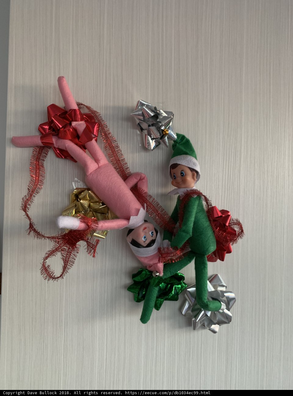 Elf on the Shelf playing with a hanging toy