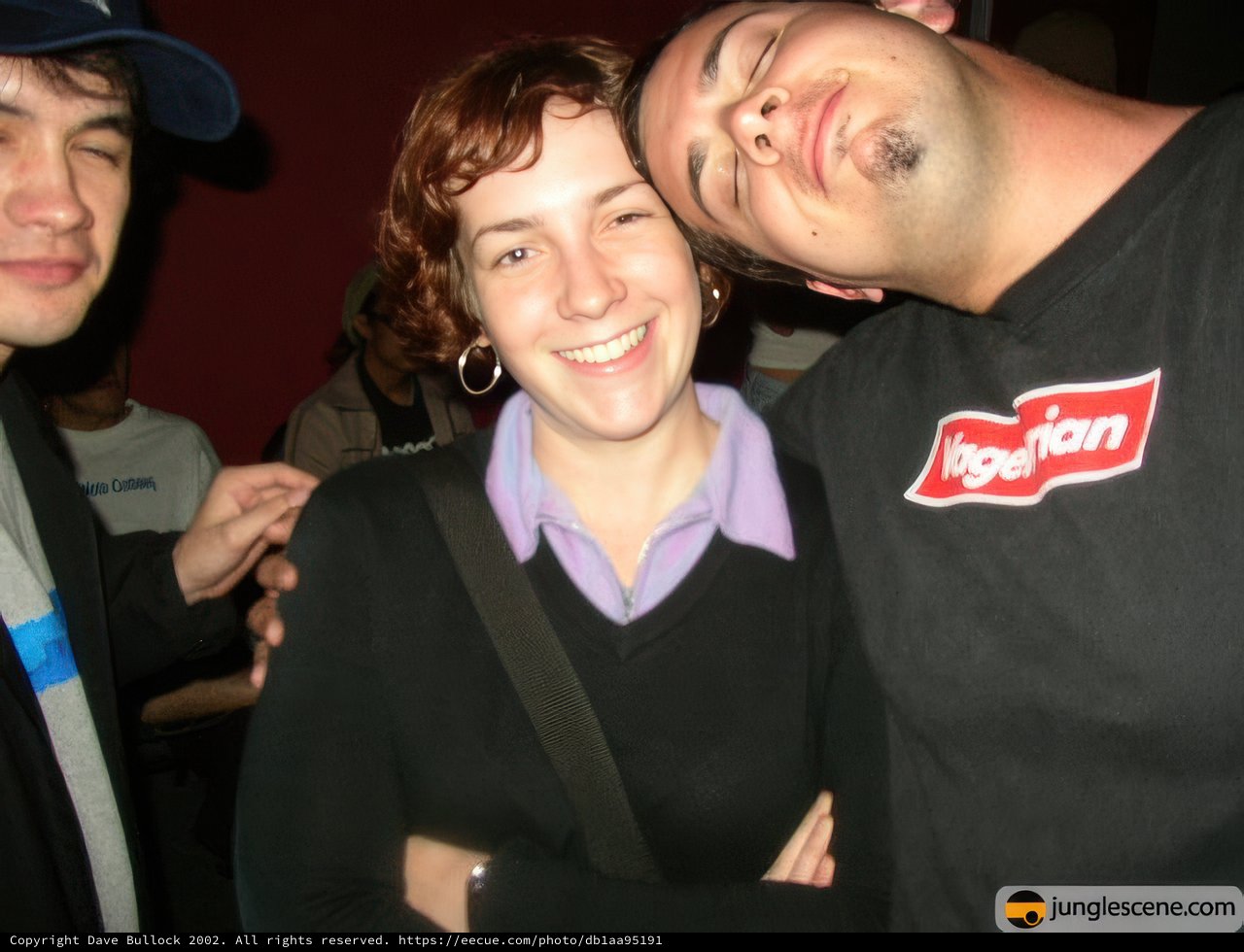 Smiling Man in Black Shirt and Baseball Cap
