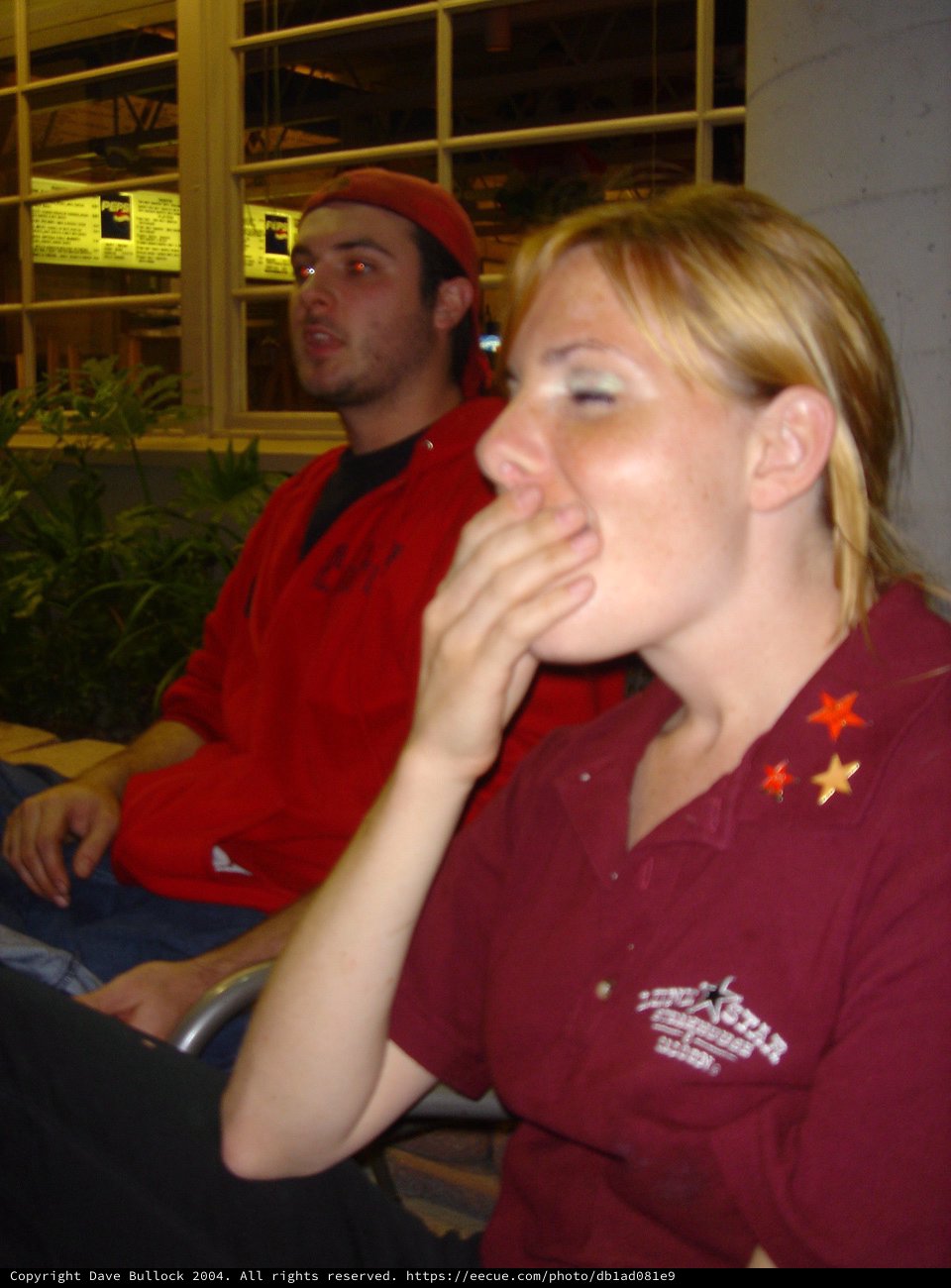 Two Friends Watching Intently at Indoor Event