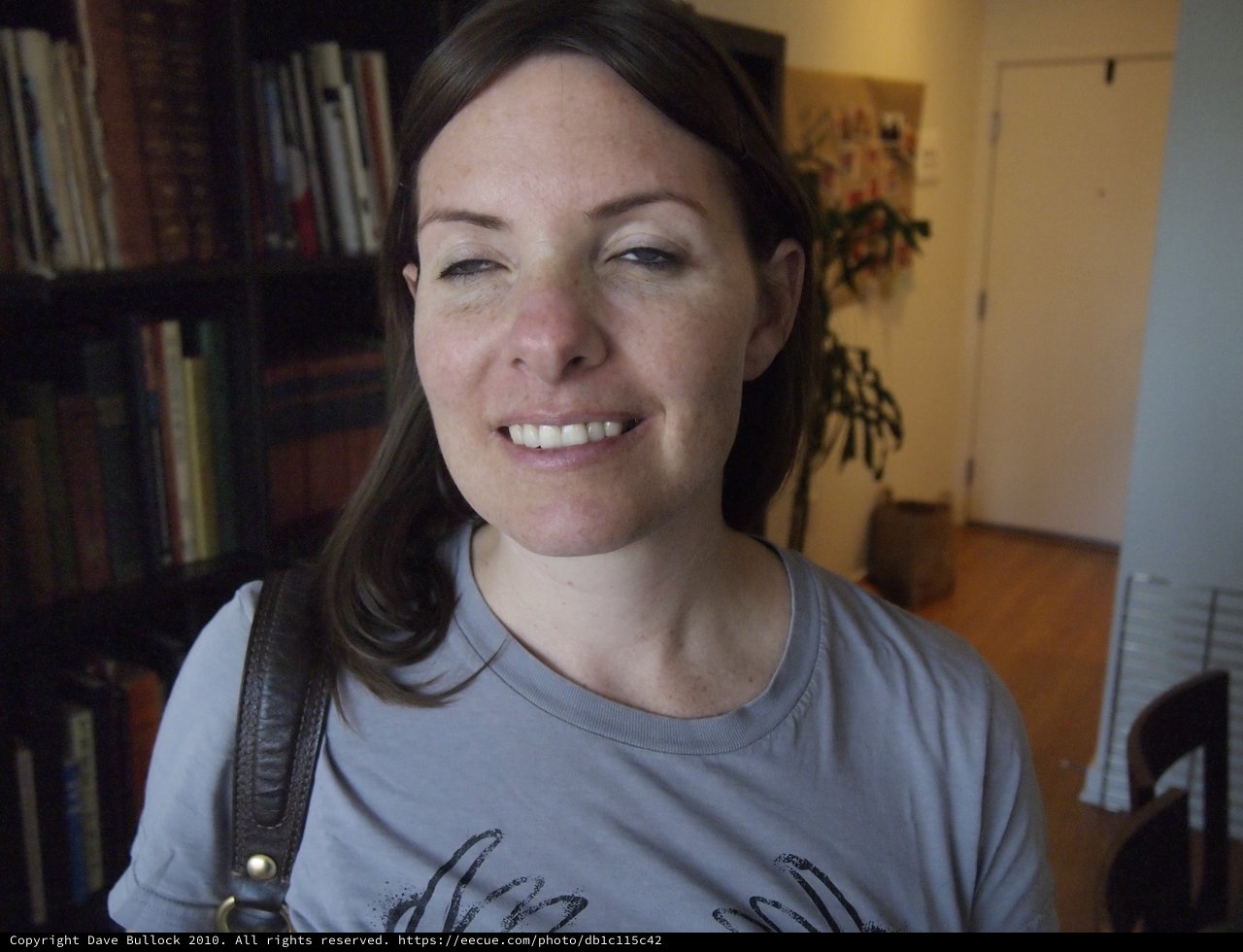 Smiling Woman with Dark Hair in Home Library