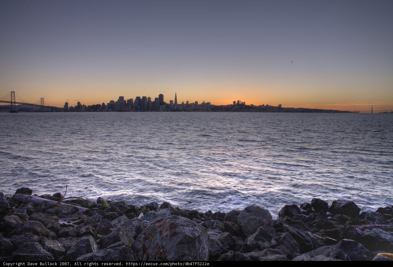 Rocky Shoreline Overlooking Bay at Sunset