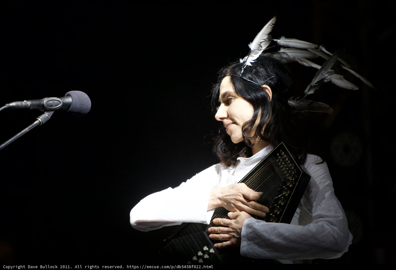 PJ Harvey Playing the Accordion with Feather Headpiece