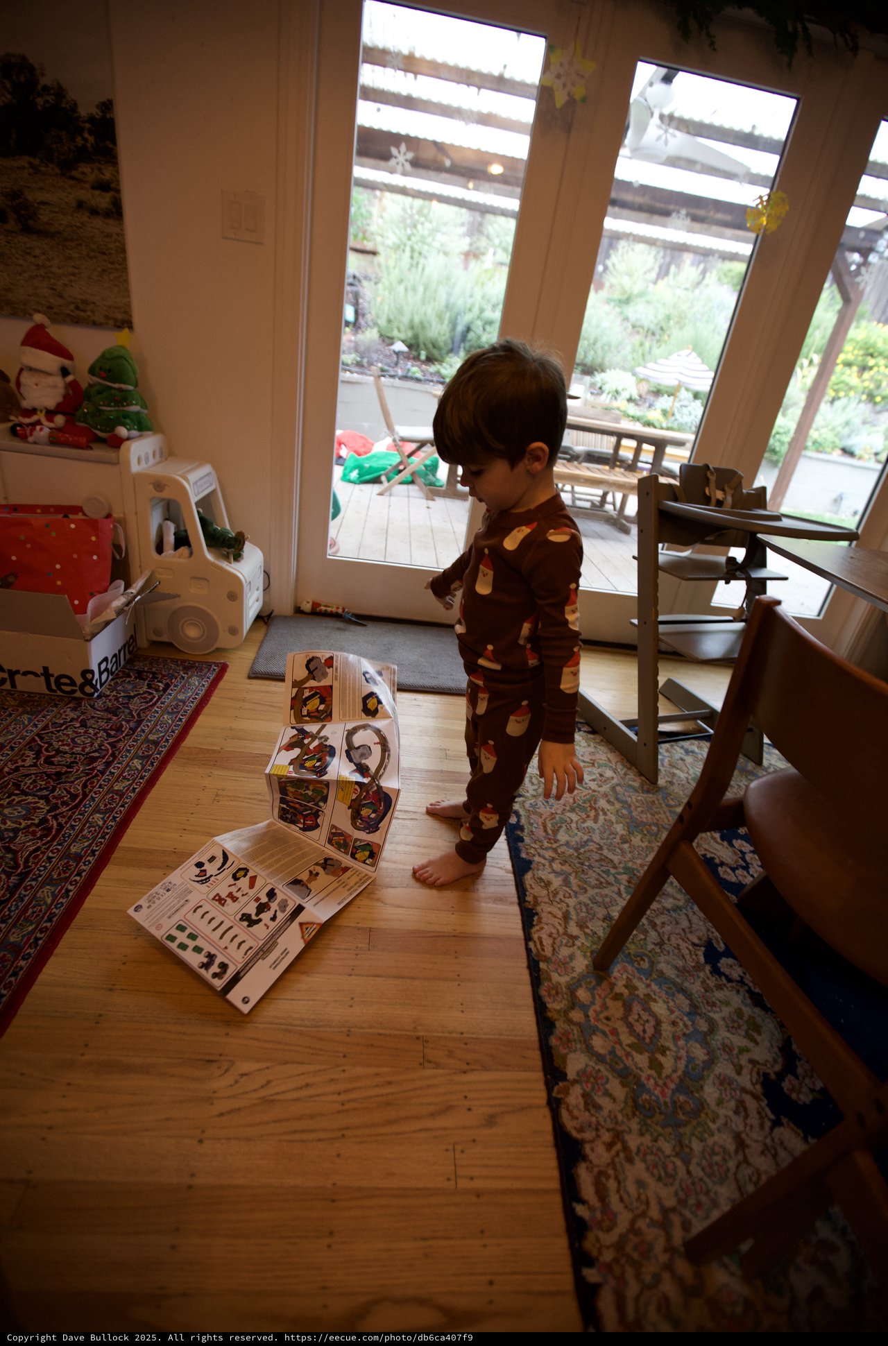 Toddler in Holiday Pajamas Playing with Puzzle at Home