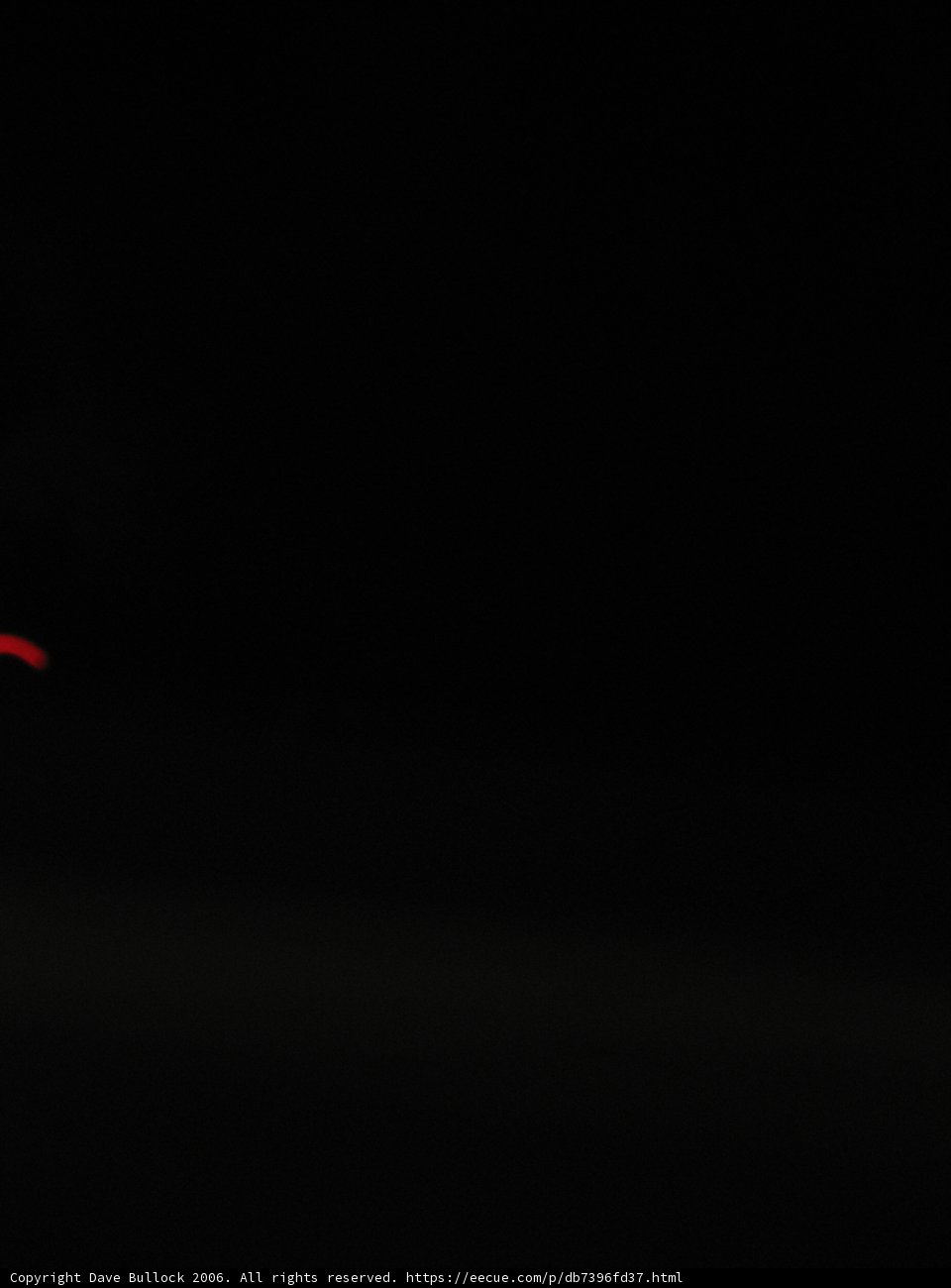 Red Car Racing Through the Night Sky