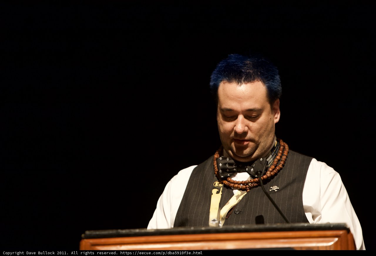 Blue-haired Speaker at Defcon Podium