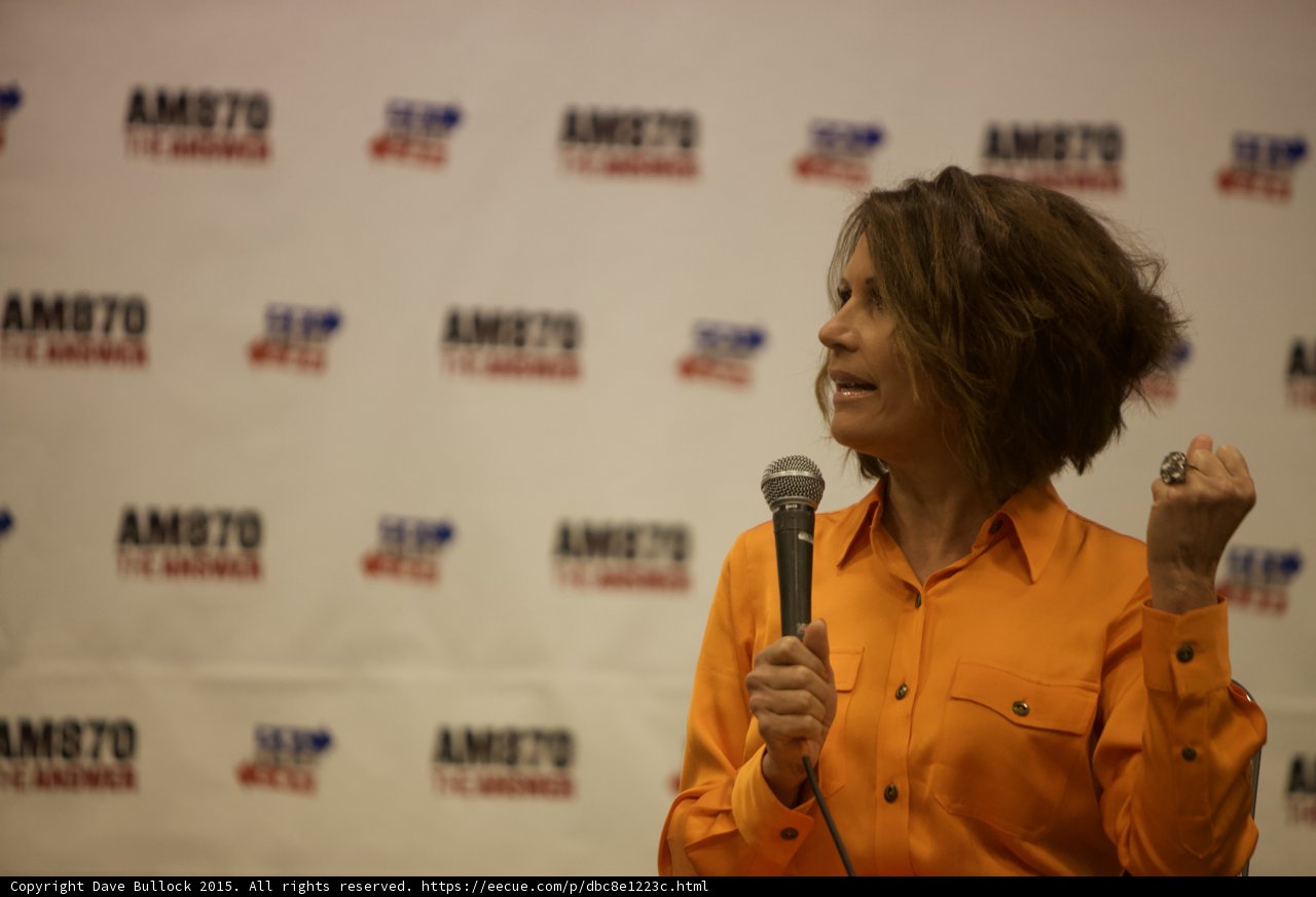 Woman Holds Mic at Political Event
