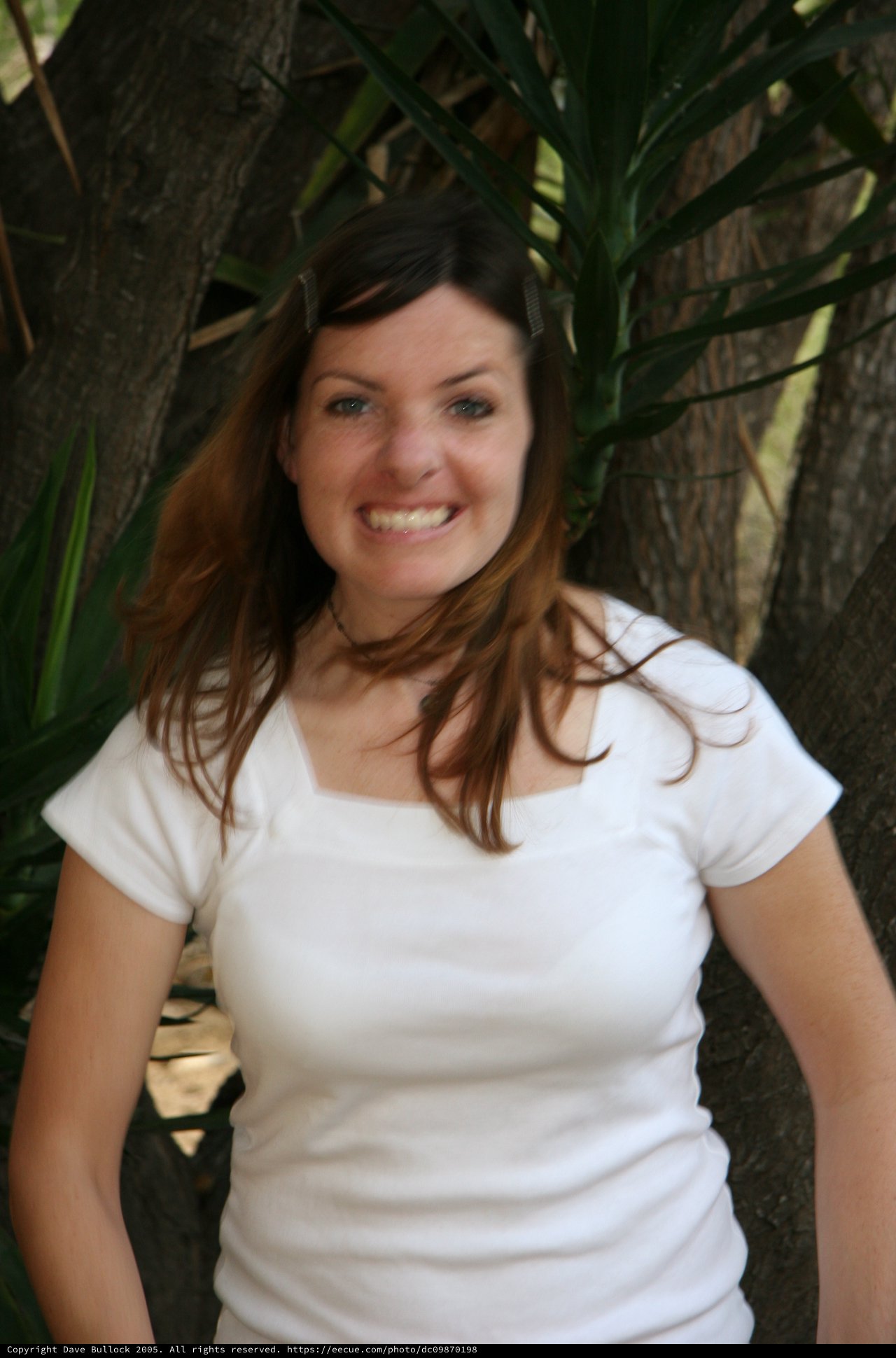 Smiling Young Woman Outdoors Among Tropical Foliage