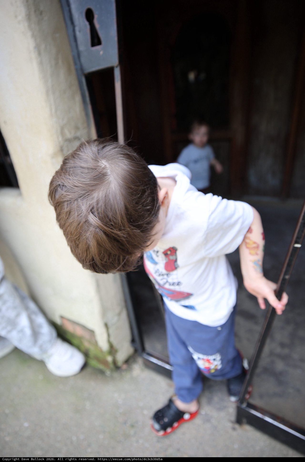 Young Boy Peering Through Mysterious Doorway at Fantasyland