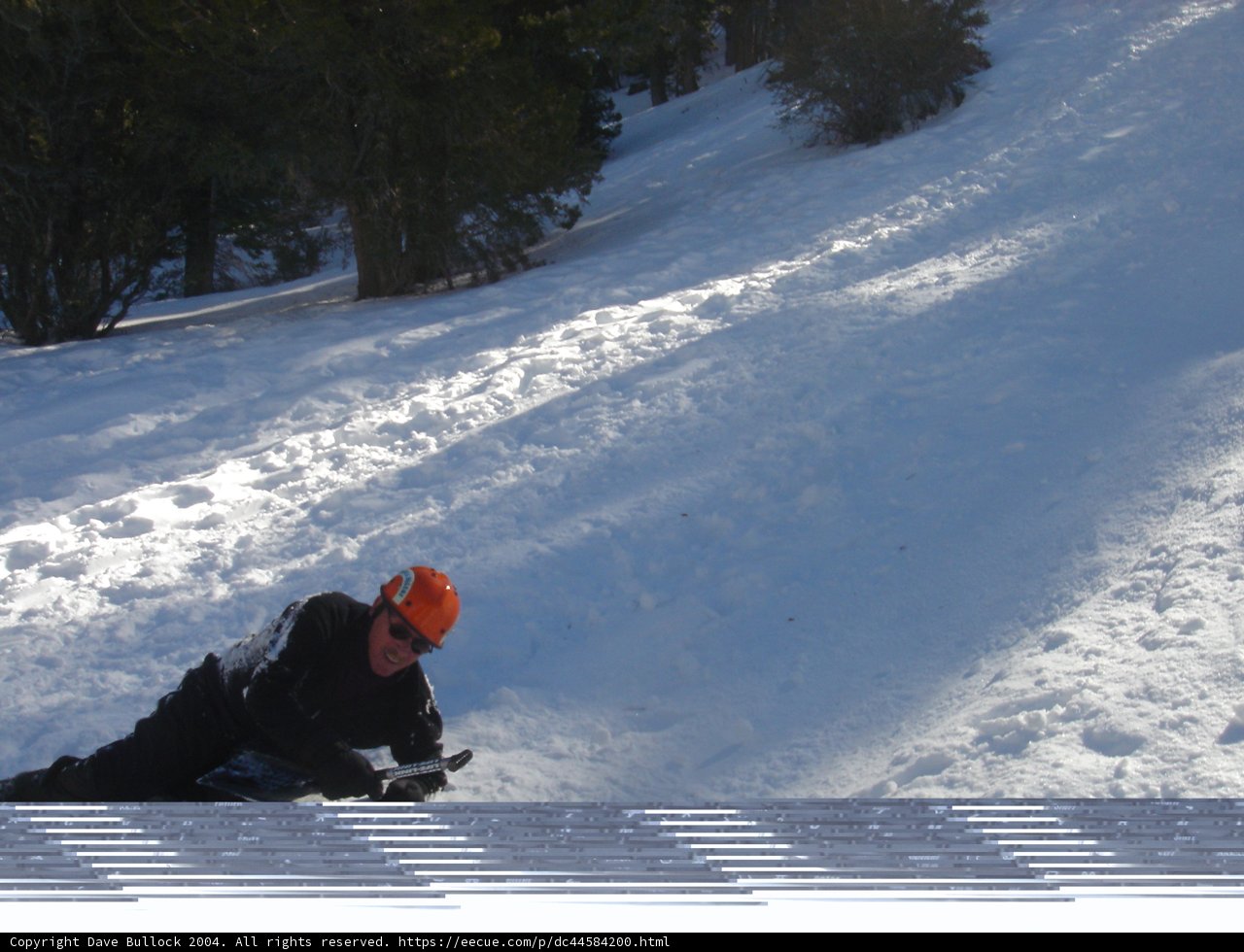 Snowboarder carving down the slope