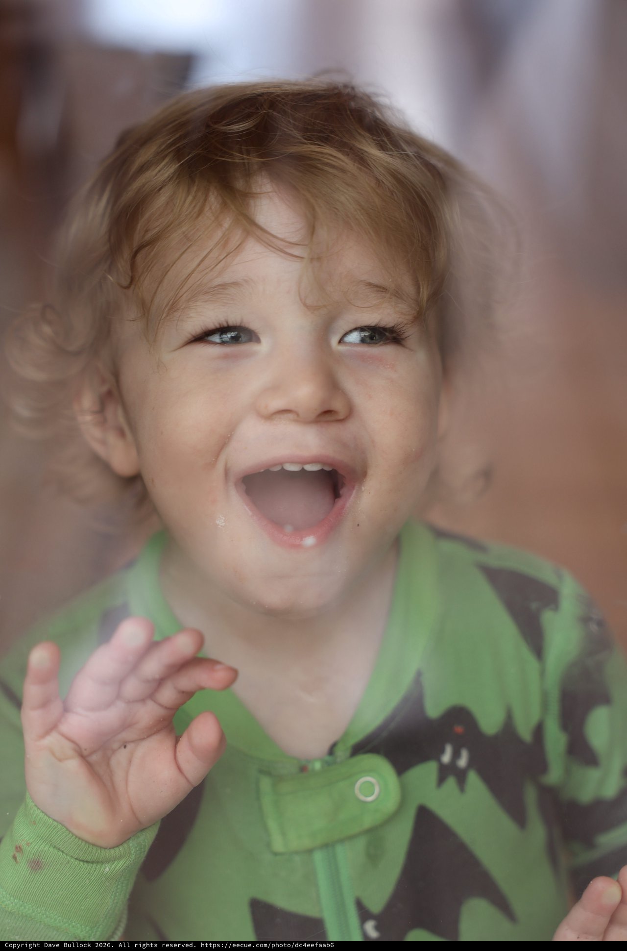 Joyful Toddler with Bright Smile and Wavy Hair