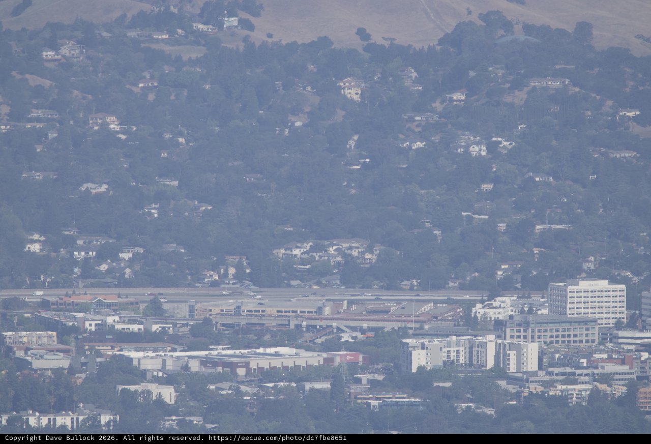 Hazy Bay Area Cityscape with Airport Runway Below Hills