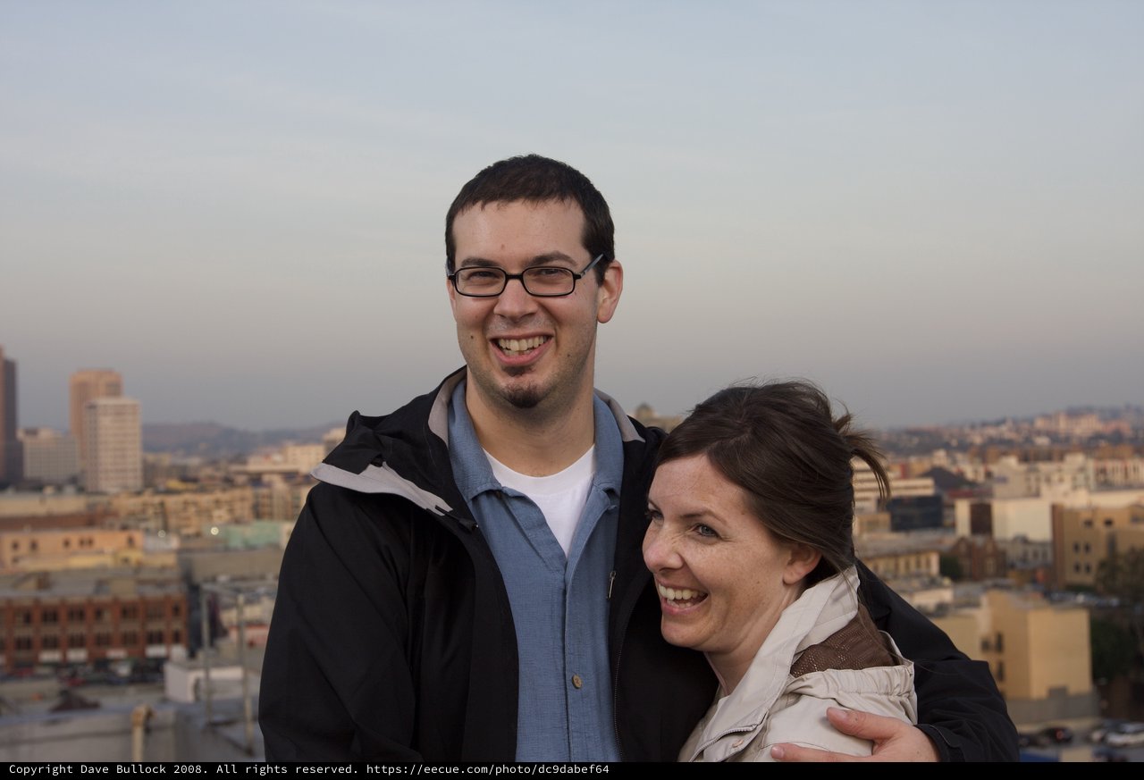 Couple Smiling Together Against City Skyline