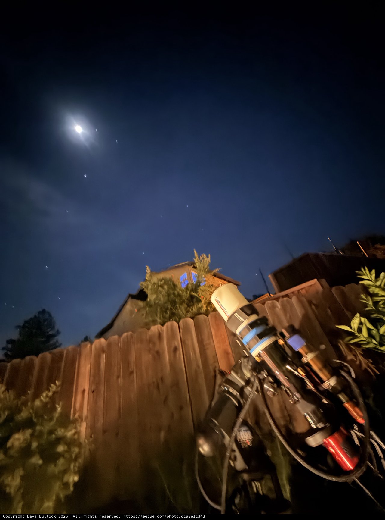 Backyard Telescope Under Moonlit Night Sky