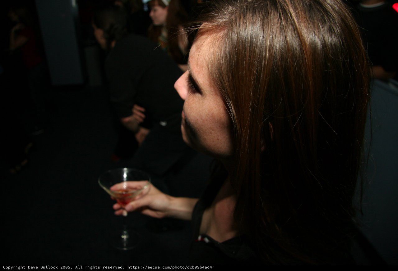 Woman with Cocktail at Dimly Lit Nightclub