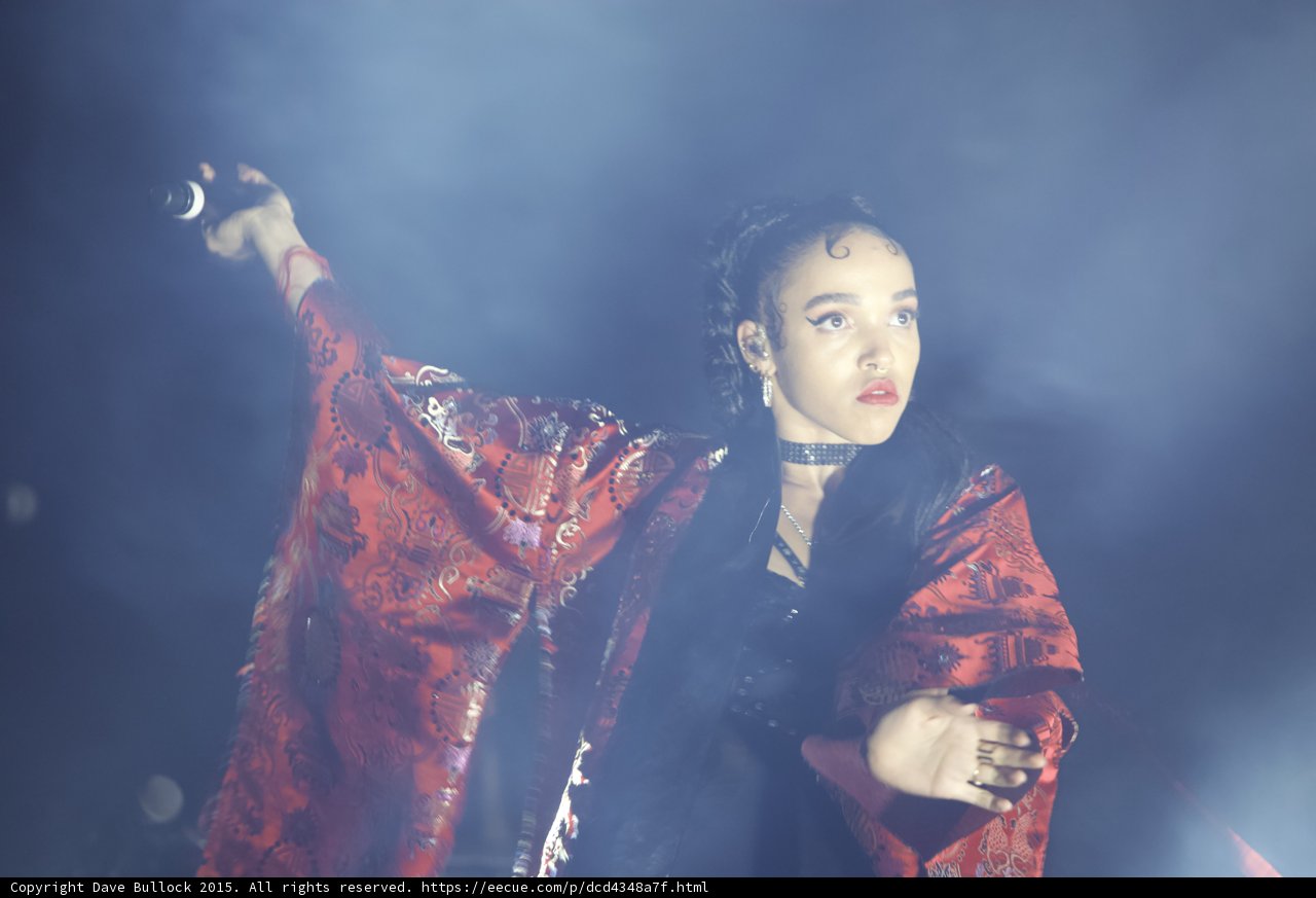 FKA twigs Portrait Microphone Extended Face Upward Baby Hairs Hoop Earrings Black Choker Red Lipstick