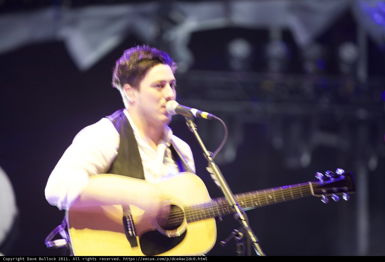 Man Entertains Coachella Crowd with Acoustic Guitar and Microphone