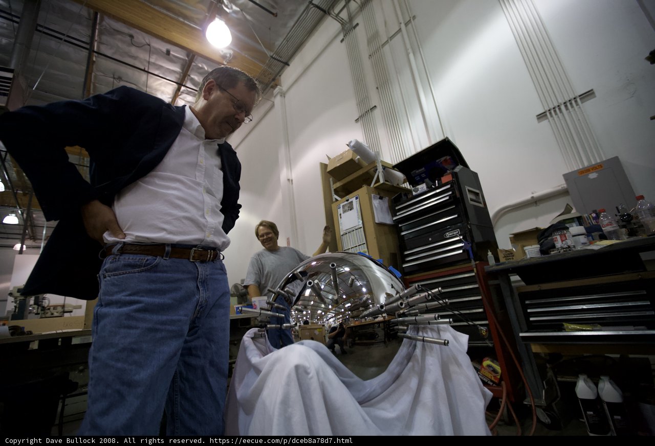 Standing next to the giant metal piano