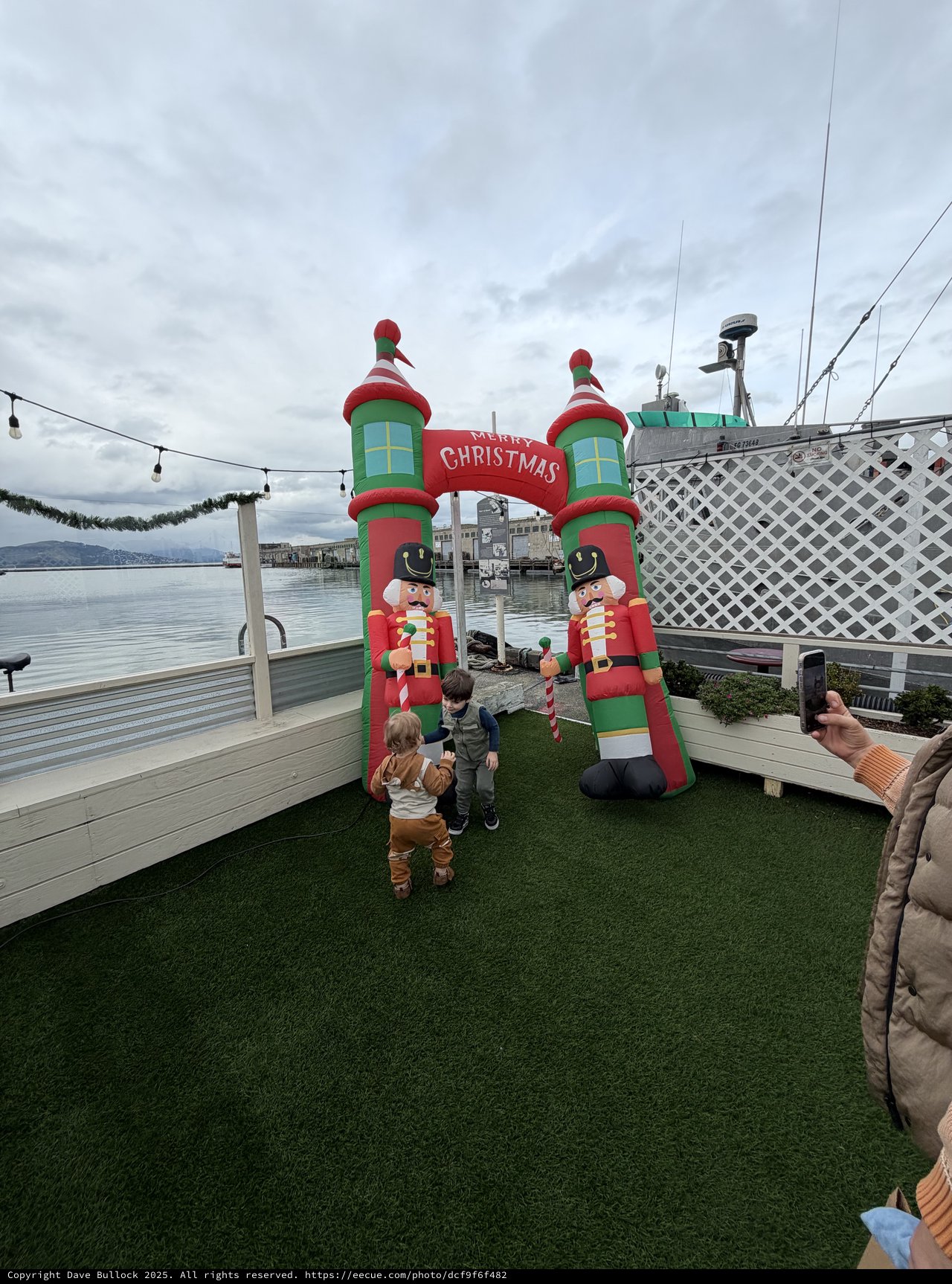 Children Explore Inflatable Christmas Nutcracker Archway by Waterfront