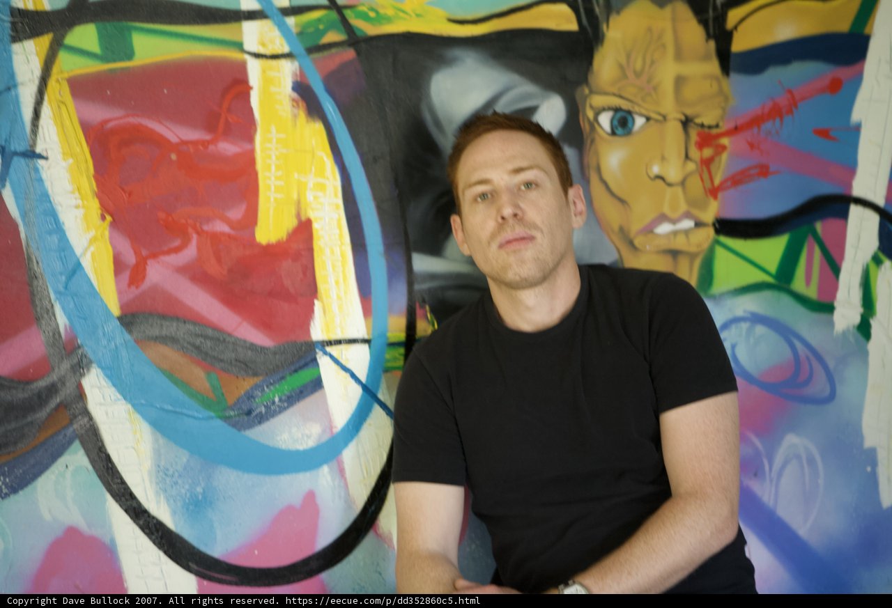 Portrait of a Man in Front of a Colorful Wall