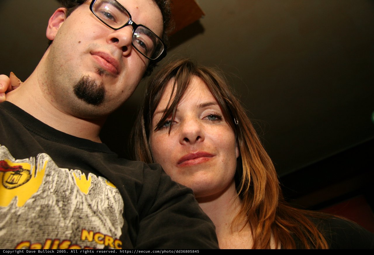 Two Friends Posing Close Together at Night