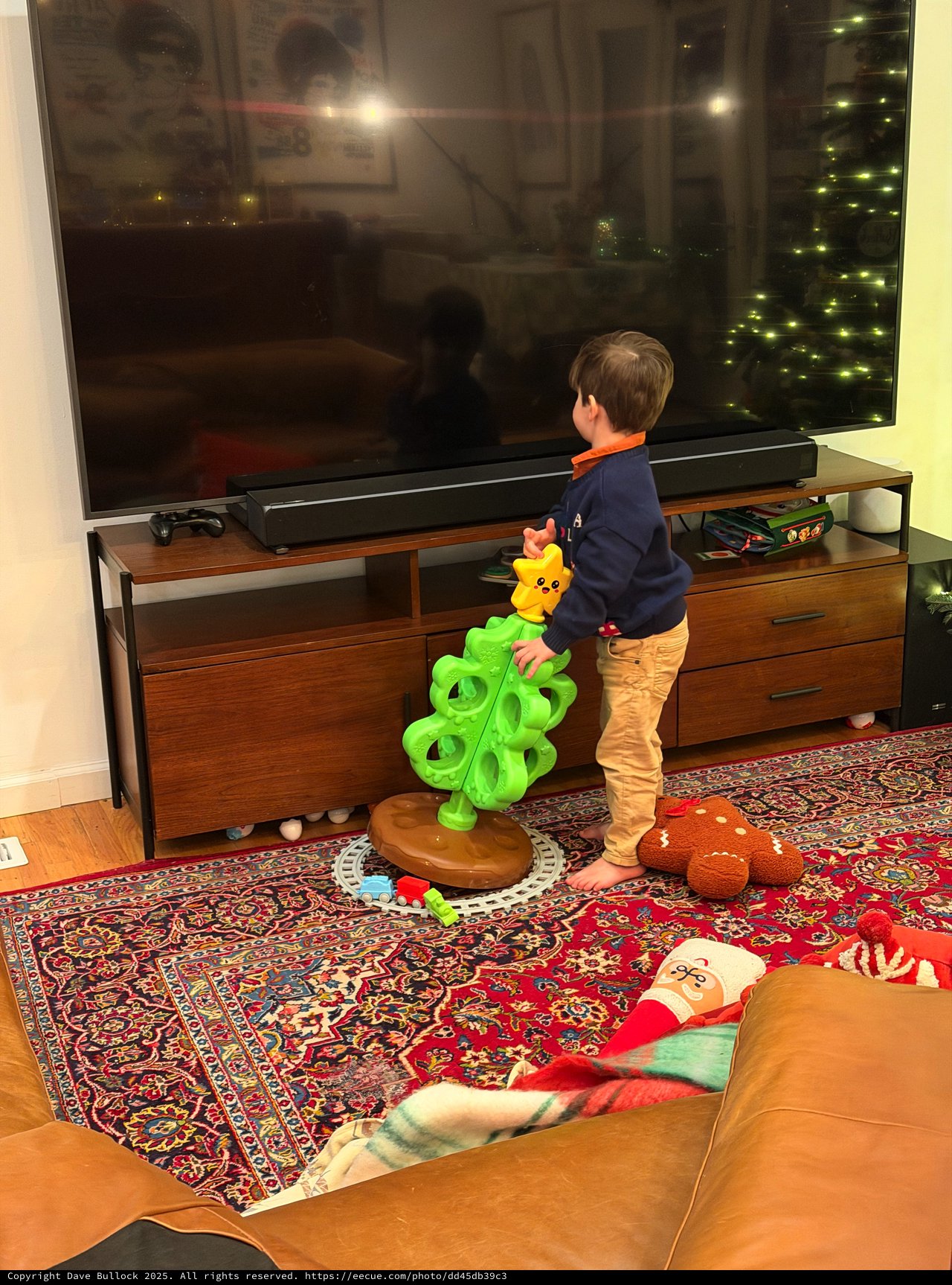 Young Child Playing with Bright Green Toy in Living Room