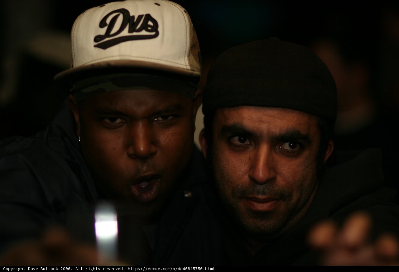 Two Men Sporting Their Baseball Caps