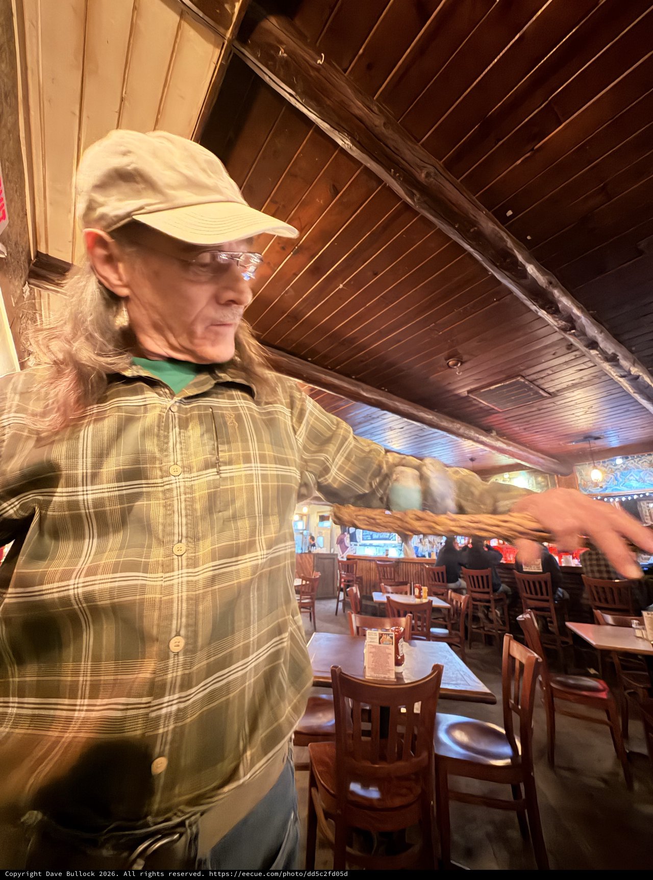 Long-Haired Patron Gesturing in Santa Fe Restaurant