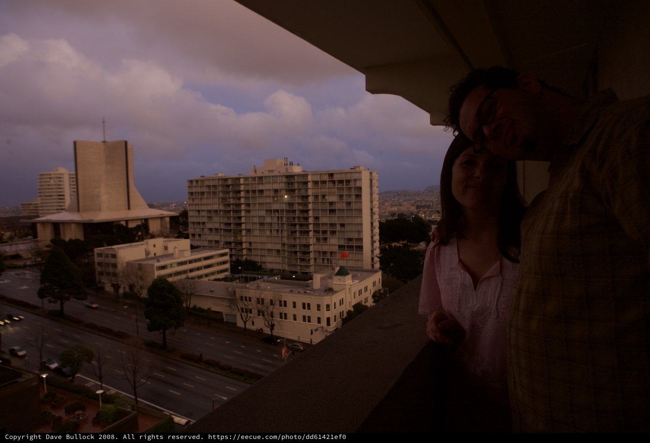 Couple Embracing on Hotel Balcony at Dusk