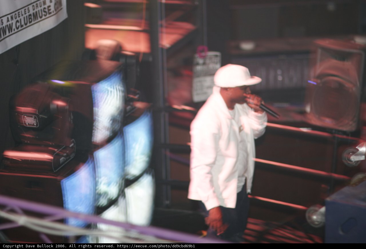 Man in White Jacket and Hat on Stage