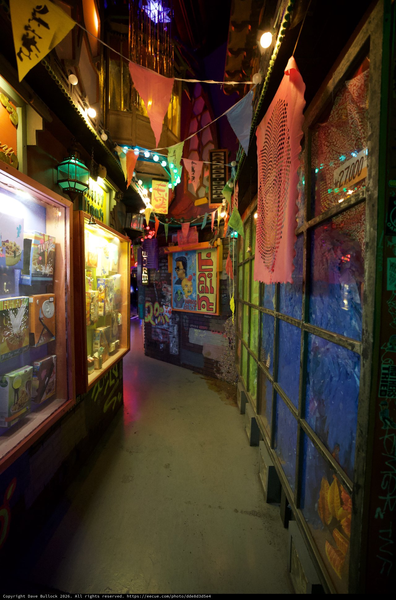 Colorful Narrow Alleyway with Festive Decorations and Art