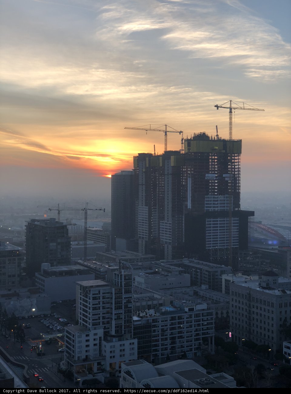 Urban Sunset with Construction Cranes